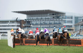 The runners take the first flight in front of the stands at Doncaster