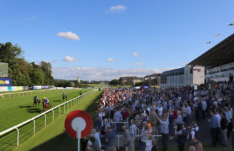 Crowd in the stands watching the horses run in at Hamilton PArk
