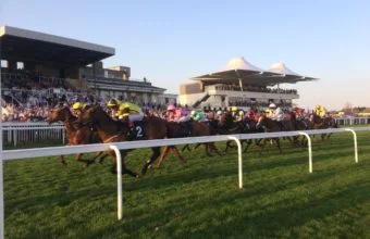 Horses pass grand stands at Bath