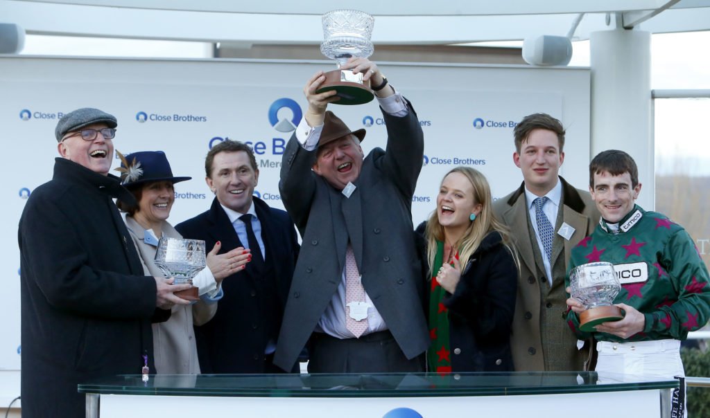Sir AP McCoy presenting Brian Hughes and owner Tim Radford with Mick Channon after winning The Close Brothers Novices' Handicap Chase at the Cheltenham Festival with Mister Whitaker