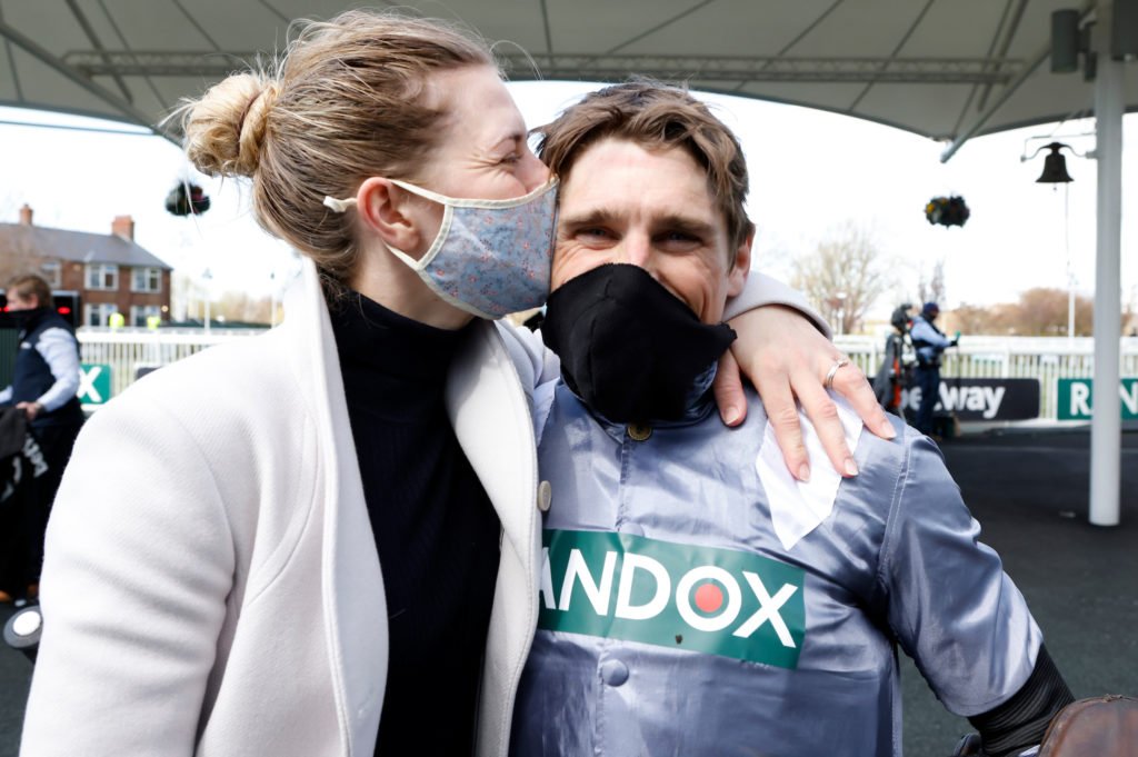 Bridget Skelton gives Harry Skelton a kiss after winning The Betway Mersey Novices' Hurdle at Aintree