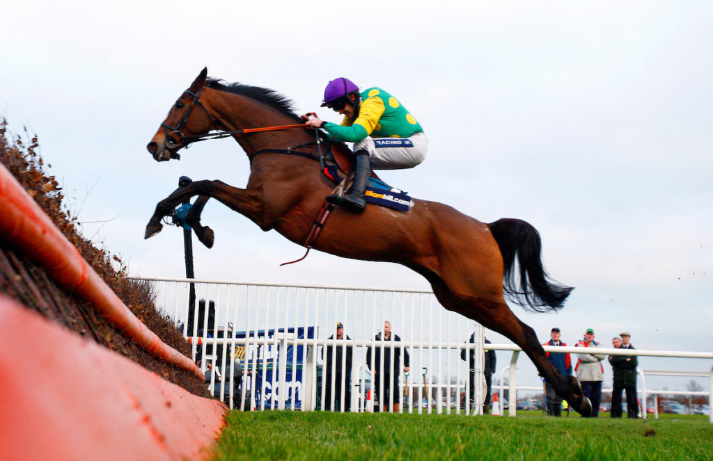 Kauto Star and Ruby Walsh jumping the last winning The William Hill King George VI Chase