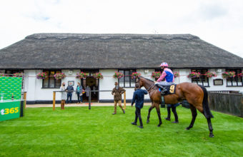 Han Solo Berger and George Wood greeted by trainer Chris Wall after winning, in the iconic Newmarket July Course winners enclosure