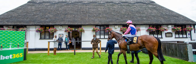 Han Solo Berger and George Wood greeted by trainer Chris Wall after winning, in the iconic Newmarket July Course winners enclosure