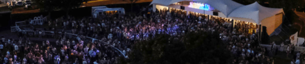 Crowd in the Epsom parade ring as music starts and sun sets