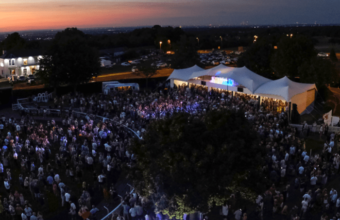 Crowd in the Epsom parade ring as music starts and sun sets