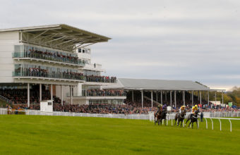 Horses taking the bend after passing the grandstand at Wetherby