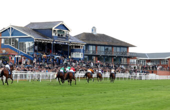 Sweet Glance and Kevin Stott winning with the Leicester Stand behind