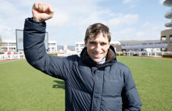 Harry Skelton in the empty parade ring with his fist in the air