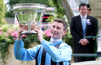 Oisin Murphy and trophy after winning The King Charles III Stakes at Ascot
