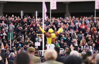 Paul Townend arms aloft being welcomed into the winners enclosure on Galopin Des Champs after winning the 2024 Gold Cup