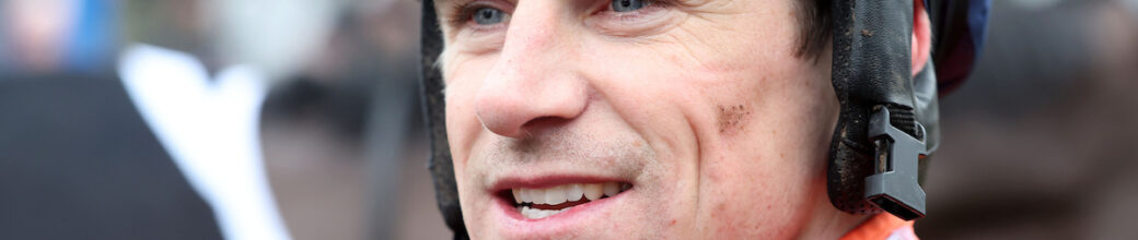 Harry Skelton looking past the camera with small mud splatters on him