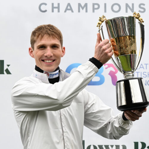 Harry Cobden celebrating with the Champion Jockey trophy in 2024 at Sandown