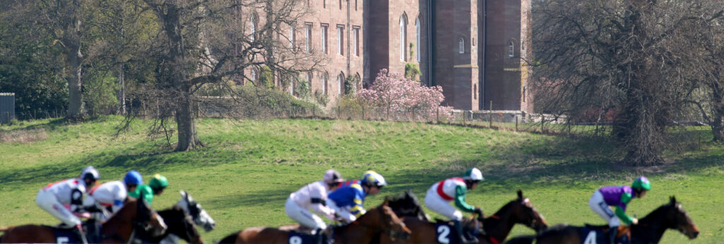 Runners passing Scone Palace in The William Hill Best Odds Guaranteed Handicap Hurdle at Perth