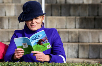 Woman reading a racecard