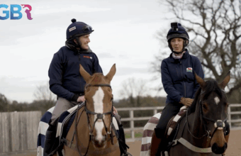 Alan Johns riding and talking with a woman